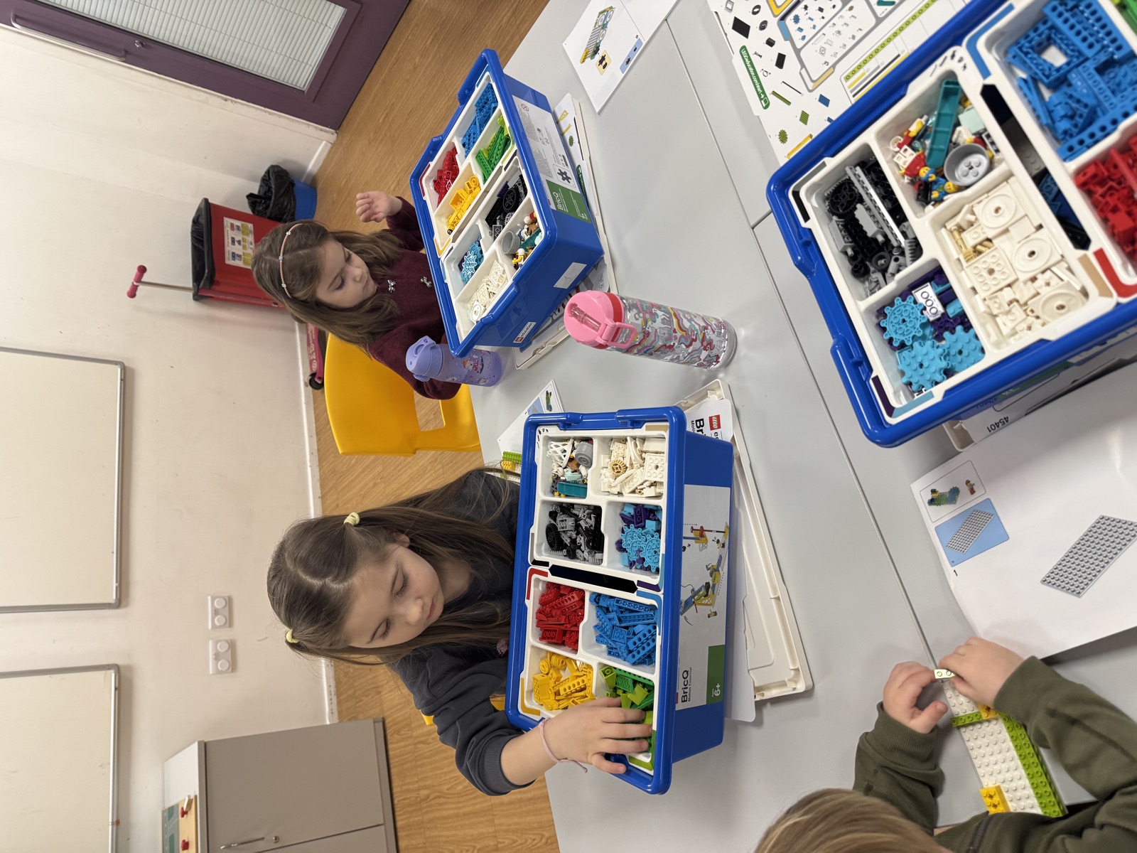 Two children building with LEGO Education sets at a table during a session.