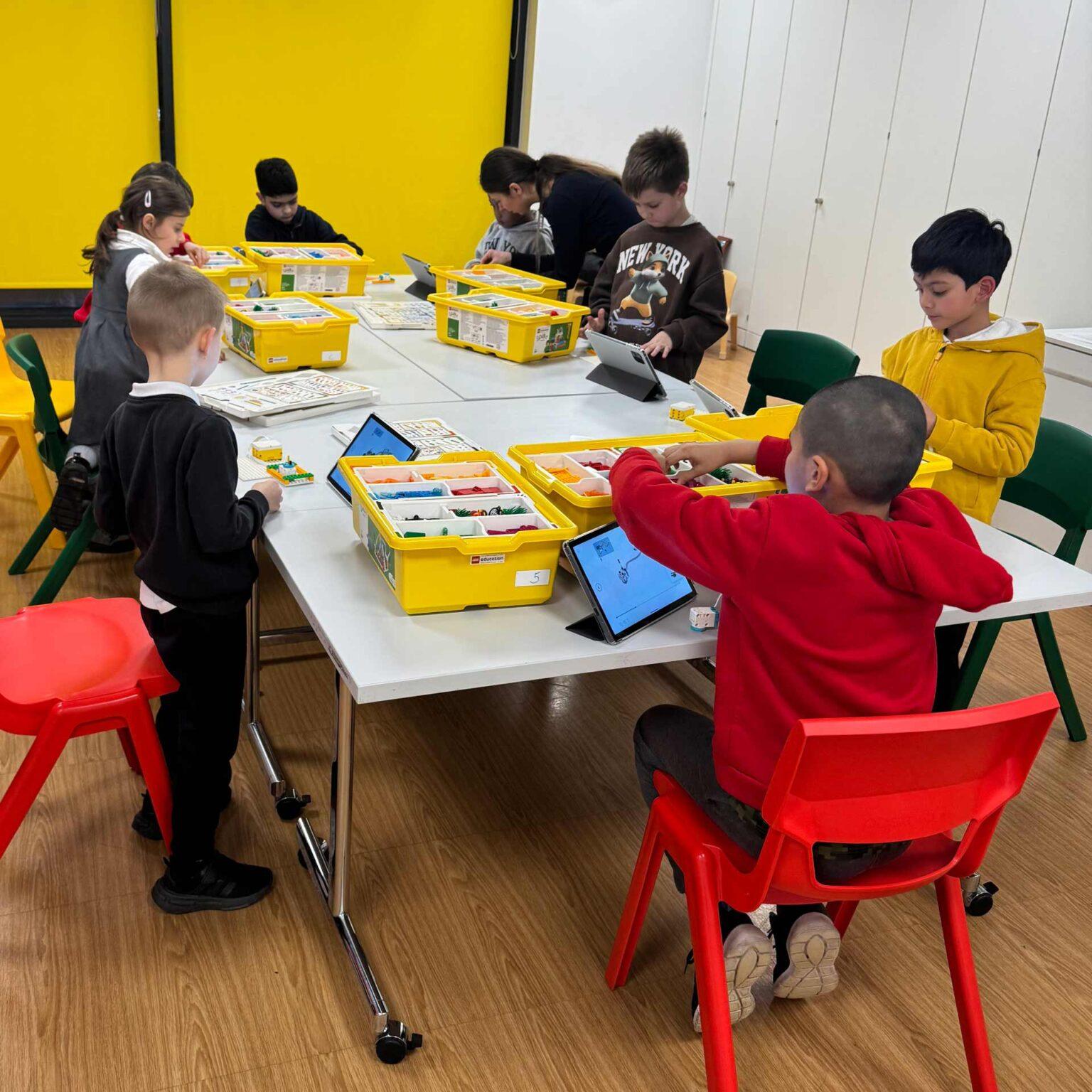 Children building and testing models together during a hands-on STEM session.